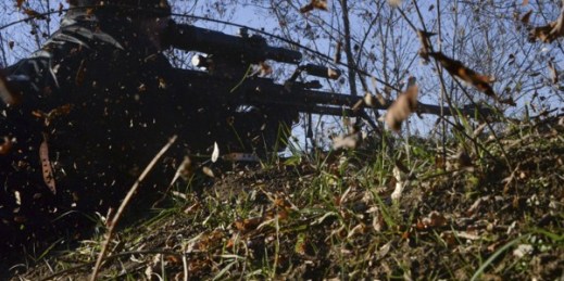 A pro-Russian rebel fires sniper rifle toward Ukrainian army positions at the frontline near Peski village, Donetsk, eastern Ukaine, Nov. 21, 2014 (AP photo by Mstyslav Chernov).