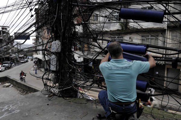 Electricity, telephone, cable and internet cables in a favela in Rio de Janeiro, Brazil, Oct. 10, 2008 (photo by Flickr user Padmanaba01 licensed under the Creative Commons Attribution-ShareAlike 2.0 Generic license).