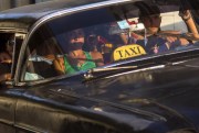 A taxi driver transports a car full of passengers in Havana, Cuba, Feb. 17, 2015 (AP photo by Ramon Espinosa).