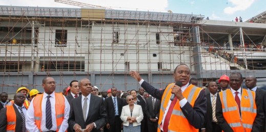 Kenyan President Uhuru Kenyatta talks to construction workers at the Jomo Kenyatta International Airport expansion project in Nairobi, Kenya, Dec. 3, 2013 (AP photo by Kenya Presidential Press Services-HO).