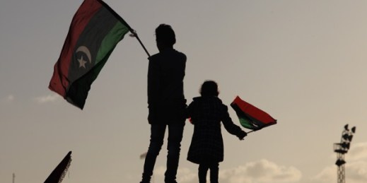 Libyan children wave national flags as they look out over Tahrir Square, during the second anniversary of the uprising that toppled longtime dictator Moammar Gadhafi, Benghazi, Libya, Feb, 17, 2013 (AP photo by Mohammad Hannon).