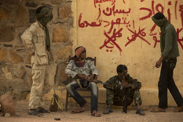 Rebels from the National Movement for the Liberation of the Azawad (NMLA) stand guard outside the former governor’s office, Kidal, Mali, July 26, 2013 (AP photo by Rebecca Blackwell).