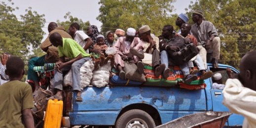 Villagers sitting on the back of a small truck as they, and others, flee the recent violence near the city of Maiduguri, Nigeria, Jan. 27, 2015 (AP photo by Jossy Ola).