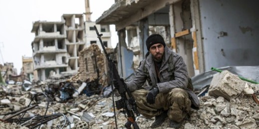 A Syrian Kurdish sniper sits among the rubble in Kobani, Syria, Jan. 30, 2015 (AP photo).