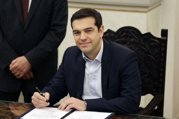 Greek Prime Minister Alexis Tsipras poses for the photographers after taking a secular oath at the Presidential Palace in Athens, Jan. 26, 2015 (AP photo by Thanassis Stavrakis).