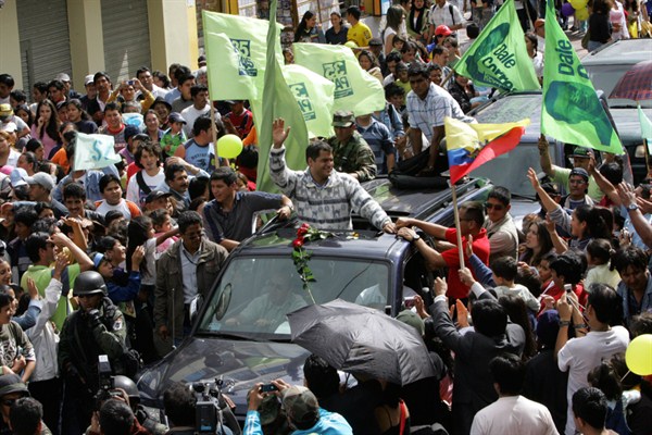 Ecuadorian President Rafael Correa waves to supporters during a rally in Banos, Ecuador, April 13, 2007 (AP photo by Dolores Ochoa).