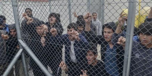 Migrants shout behind an iron fence at the Foreigners Detention Center in Amygdaleza, Greece, Feb. 14, 2015 (AP Photo/InTime News/Nikos Halkiopoulos).
