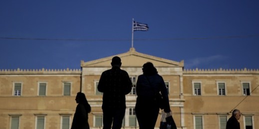 People walk past the Greek parliament in Athens, Greece, March 4, 2015 (AP photo by Petros Giannakouris).