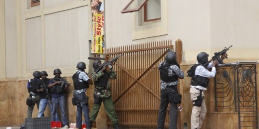 Armed special forces aim their weapons at the Westgate Mall in Nairobi, Kenya after gunmen threw grenades and opened fire during an attack that left multiple dead and dozens wounded, Sept. 21, 2013 (AP photo by Khalil Senosi).