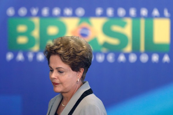 Brazilian President Dilma Rousseff leaves at the end of a government ceremony at the Planalto presidential palace in Brasilia, Brazil, March 16, 2015 (AP photo by Eraldo Peres).