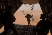 A multinational group of paratroopers exit a C-130 H3 aircraft over a drop zone during Exercise Flintlock 2014, Agadez, Niger, March 2, 2015  (U.S. Air National Guard photo by Tech. Sgt. Eugene Crist).