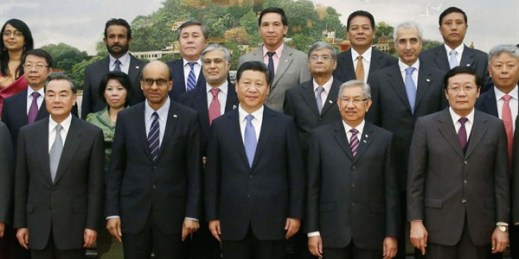 Chinese President Xi Jinping and leaders of other countries line up for a photo at a ceremony to mark the decision to set up the Asian Infrastructure Investment Bank, Beijing, China, Oct. 24, 2014 (Pool photo by Kyodo News via AP Images).