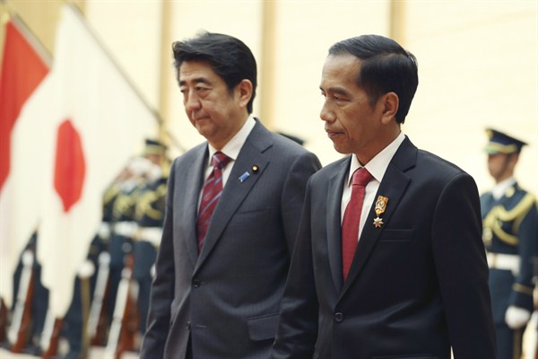 Japanese Prime Minister Shinzo Abe and Indonesian President Joko Widodo review a guard of honor prior to their meeting at Abe’s official residence in Tokyo, March 23, 2015 (AP photo by Koji Sasahara).