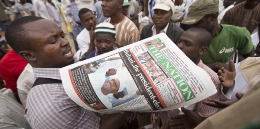 A newspaper distributor counts copies to give to eager sellers the morning after the presidential election, Kano, Nigeria, April 1, 2015 (AP photo by Ben Curtis).