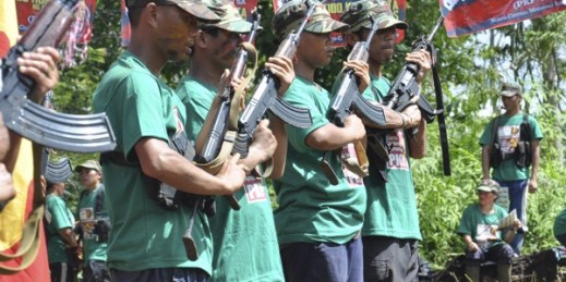Communist New People’s Army (NPA) rebels hold weapons in formation in the hinterlands of Davao, Philippines, Dec. 26, 2013 (AP photo).