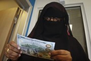 A Somali woman counts the money she collected from a money transfer service, Mogadishu, Somalia, April 8, 2015 (AP photo by Farah Abdi Warsameh).