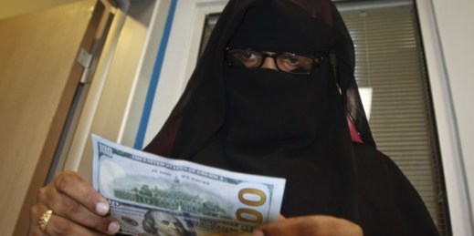 A Somali woman counts the money she collected from a money transfer service, Mogadishu, Somalia, April 8, 2015 (AP photo by Farah Abdi Warsameh).
