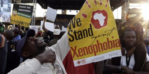 A man holds a poster reading “We Stand against Xenophobia” during a protest against recent attacks on immigrants, Johannesburg, South Africa, April 23, 2015 (AP photo by Themba Hadebe).