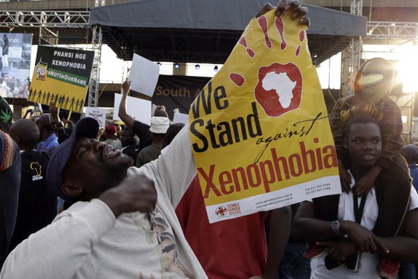 A man holds a poster reading “We Stand against Xenophobia” during a protest against recent attacks on immigrants, Johannesburg, South Africa, April 23, 2015 (AP photo by Themba Hadebe).