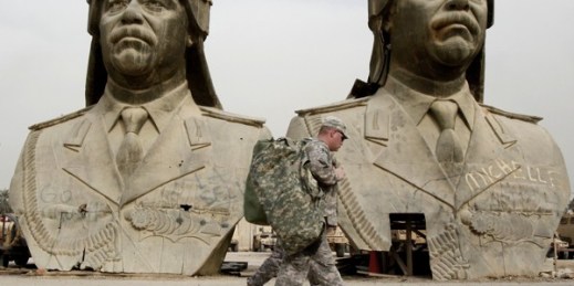 U.S. Army soldiers stroll past two bronze busts of former Iraqi president Saddam Hussein in the Green Zone in Baghdad, March 20, 2009 (AP photo by Hadi Mizban).