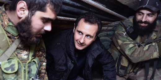 Syrian President Bashar al-Assad speaks with Syrian troops during his visit to the front line in the eastern Damascus district of Jobar, Syria, Dec. 31, 2014 (AP Photo/SANA).