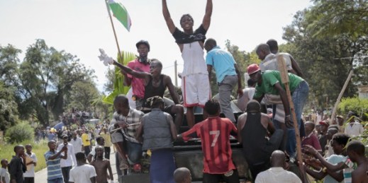 Demonstrators climb aboard a military truck as they celebrate what they perceive to be an attempted military coup d’etat, Bujumbura, Burundi, May 13, 2015 (AP photo by Berthier Mugiraneza).