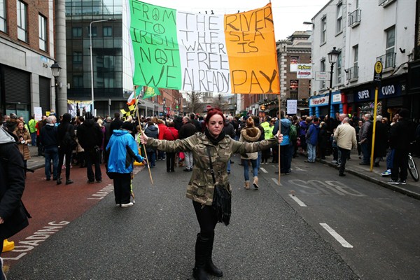 A demonstrator holds up a banner at a ‘We Won’t Pay Campaign’ anti-water charge protest outside the Irish Water headquarters, Dublin, Ireland, Nov. 29, 2014 (Brian Lawless/PA Wire URN:21600475, Press Association via AP Images).