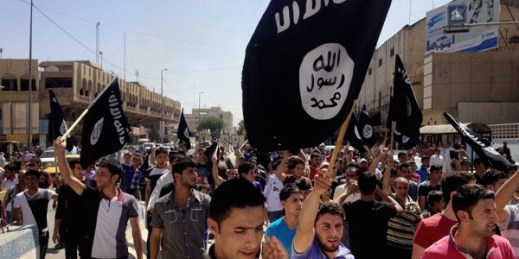 Demonstrators chant pro-Islamic State group slogans as they wave the group’s flags in front of the provincial government headquarters, Mosul, Iraq, June 16, 2014 (AP photo).