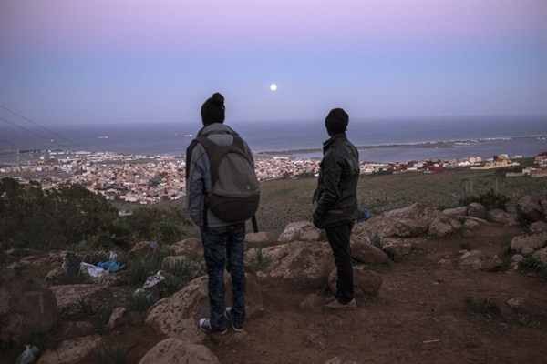Young Malian migrants watch the border between Morocco and the Spanish enclave of Melilla from a clandestine immigrant camp located at Mount Gourougou, near Nador, Morocco, Nov. 6, 2014 (AP photo by Santi Palacios).