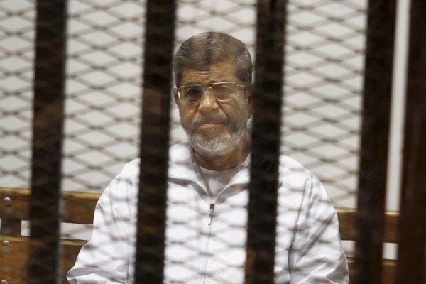 Egypt’s ousted Islamist President Mohammed Morsi sits in a defendant cage in the Police Academy courthouse in Cairo, Egypt, May 8, 2014 (AP photo by Tarek el-Gabbas).