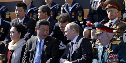 Russian President Vladimir Putin speaks with Chinese President Xi Jinping during the Victory Parade marking the 70th anniversary of the surrender of Nazi Germany in World War II, Moscow, Russia, May 9, 2015 (AP photo by Alexander Zemlianichenko).
