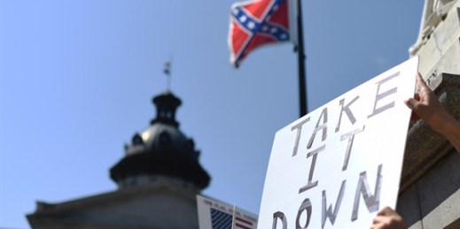 Protesters hold a sign during a rally to take down the Confederate flag at the South Carolina Statehouse, Columbia, S.C., June 23, 2015 (AP photo by Rainier Ehrhardt).