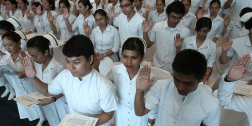 New Filipino professional nurses take their oaths during a ceremony at a convention center, Manila, Philippines, Sept. 20, 2010 (AP photo by Bullit Marquez).