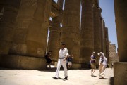 An Egyptian policeman patrols as tourists walk through the ruins of the Karnak Temple in Luxor, Egypt, June 11, 2015 (AP photo by Hassan Ammar).