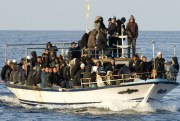 A boat loaded with migrants is spotted at sea off the Sicilian island of Lampedusa, Italy, March 7, 2011 (AP photo by Antonello Nusca).