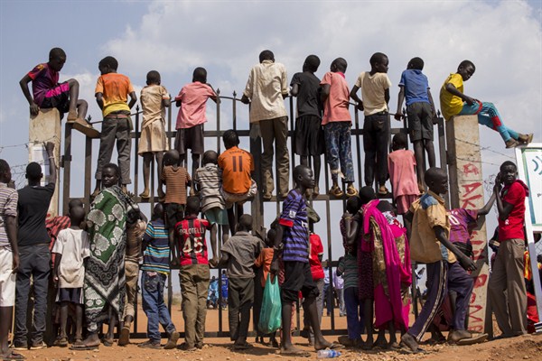 Internally displaced children are seen standing at the gate of their camp, Juba, South Sudan, Feb. 6, 2015 (U.N. photo by JC McIlwaine).