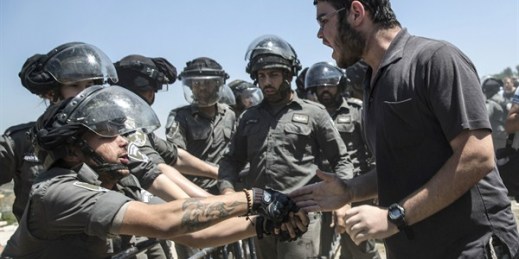 Young Israeli settlers scuffle with border police officers over the demolition of a building at the Jewish settlement of Beit El, near the West Bank town of Ramallah, Wednesday, July 29, 2015 (AP photo/Tsafrir Abayov).