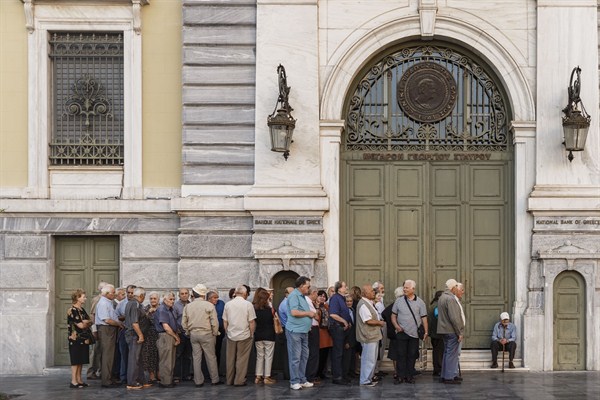 Pensioners line up as they wait to be allowed into a bank to withdraw a maximum of 120 euros for the week, July 2, 2015 (AP photo by Daniel Ochoa de Olza).