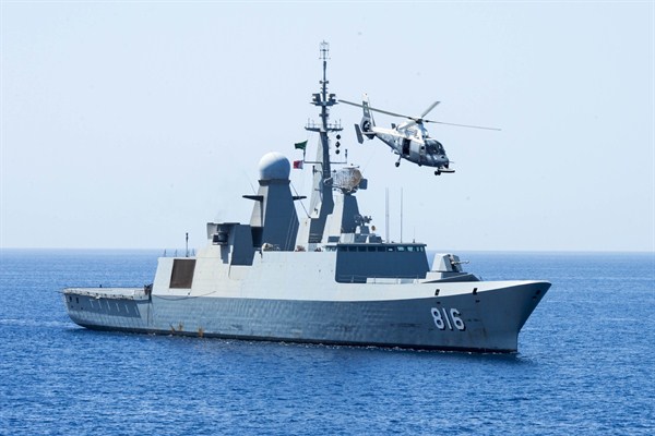 The Royal Saudi Navy frigate Al Dammam maneuvers into position, with a AS565 SA Dauphin helicopter circling overhead, during exercise "Eager Lion 2014," Gulf of Aden, May 28, 2014 (U.S. Navy photo).