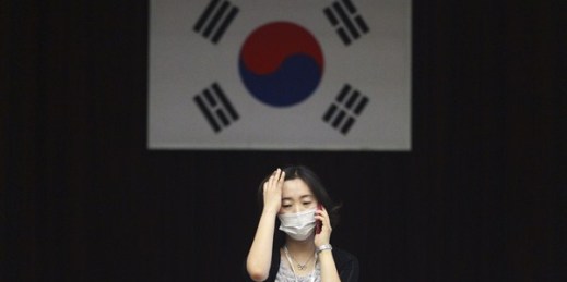 An official wearing a mask as a precaution against the MERS virus works at the Dongdaemun District Office, Seoul, South Korea, June 18, 2015 (AP photo by Ahn Young-joon).