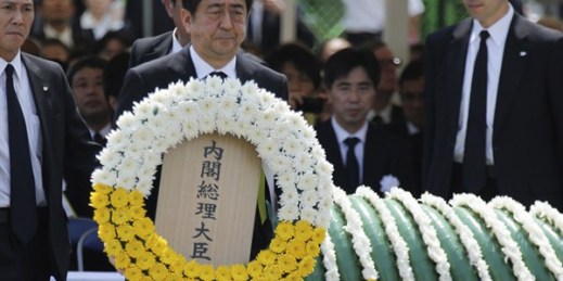 Japanese Prime Minister Shinzo Abe holds a wreath during a ceremony to mark the 70th anniversary of the Nagasaki atomic bombing, Nagasaki, southern Japan Sunday, Aug. 9, 2015 (AP photo by Eugene Hoshiko).