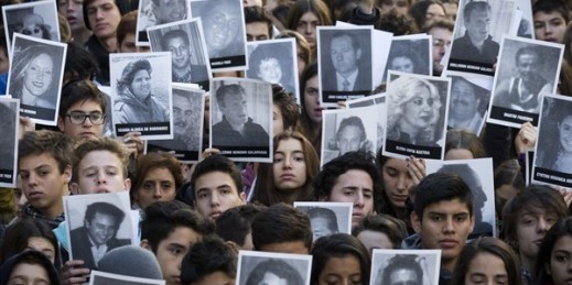 People hold up pictures of the victims from the AMIA Jewish community center bombing on the 21st anniversary of the terror attack, Buenos Aires, Argentina, July 17, 2015 (AP photo by Victor R. Caivano).