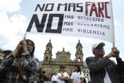 Demonstrators hold a banner that reads in Spanish "No more FARC, no more kidnapping, no more terrorism, no more violence" at a protest against the FARC, Bogota, Colombia, Feb. 15, 2013 (AP photo by Fernando Vergara).