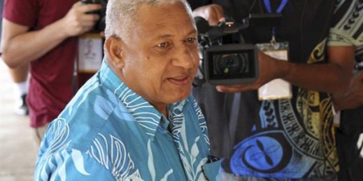 Fiji's then-military ruler Frank Bainimarama arrives at a polling station to cast his vote in a national election, Suva, Fiji, Sept. 17, 2014 (AP photo by Pita Ligaiula).