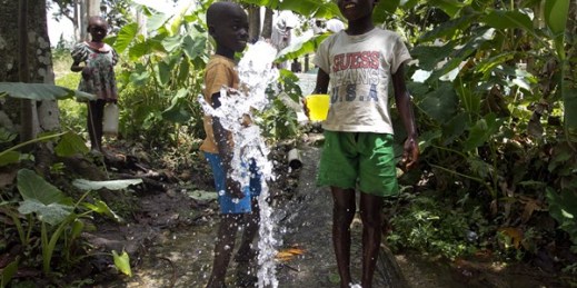 Boys drink water being pumped out of the existing potable water system, which is to be improved by the U.N. Stabilization Mission in Haiti, Saut d'Eau, Haiti, June 28, 2012 (U.N. photo by Victoria Hazou).