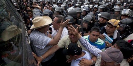 Police prevent demonstrators marking Teacher's Day from approaching the Zocalo plaza in Mexico City, May 15, 2015 (AP photo by Marco Ugarte).
