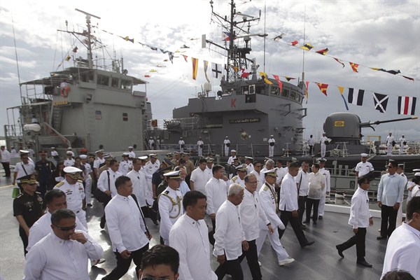 Philippine President Benigno Aquino III walks with new Philippine Navy Flag-Officer-in-Command, Rear Adm. Caesar Taccad as they view one of the newly acquired landing craft, Manila, Philippines, Aug. 10, 2015 (AP photo by Aaron Favila).