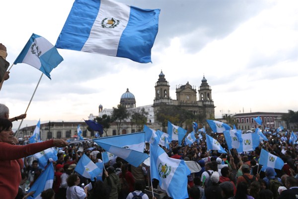 Demonstrators wave Guatemalan flags as they celebrate that Congress voted to withdraw President Otto Perez Molina's immunity from prosecution, Guatemala City, Sep. 1, 2015 (AP photo by Moises Castillo).