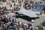 Visitors crowd around a French Rafale fighter jet on display during the last day of the Aero India 2013 at Yelahanka air base, Bangalore, India, Feb. 10, 2013 (AP photo by Aijaz Rahi).