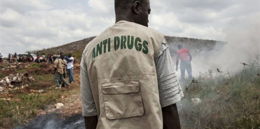A member of the Liberia National Police Anti-Drug Squad reviews the municipal dump where they are burning 880 lbs of drugs that were confiscated between 2011 and 2012, Monrovia, Liberia, March 1, 2013 (U.N. photo by Staton Winter).
